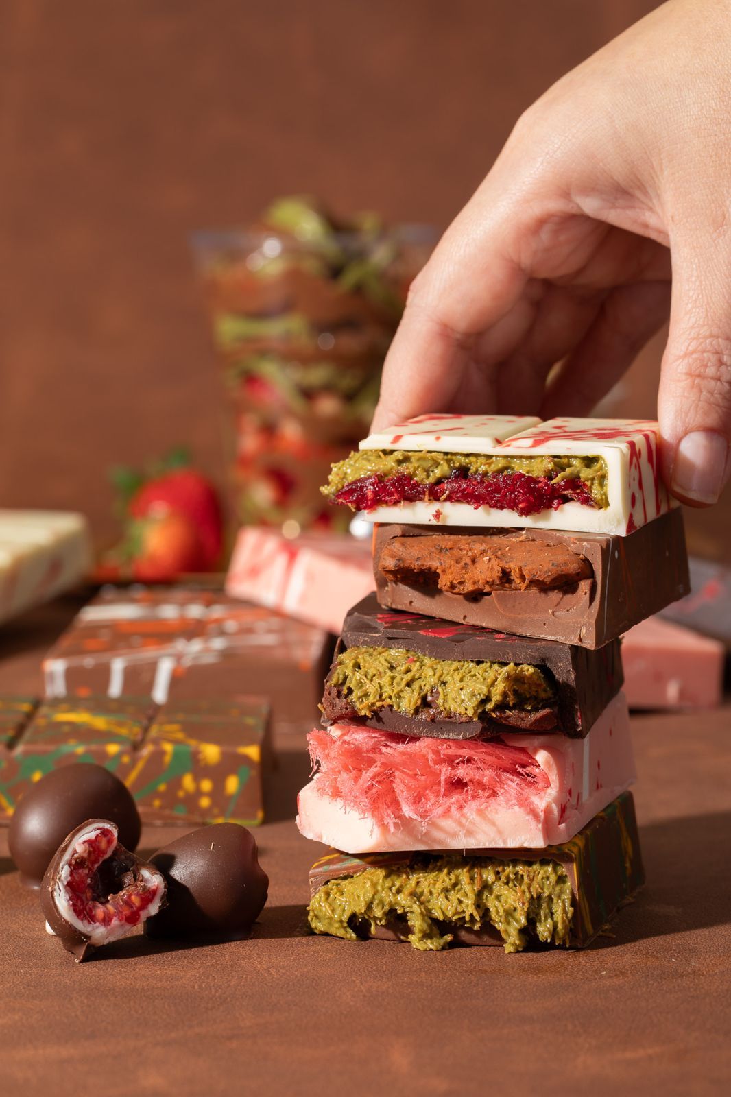 A hand lifting a stack of bar slices